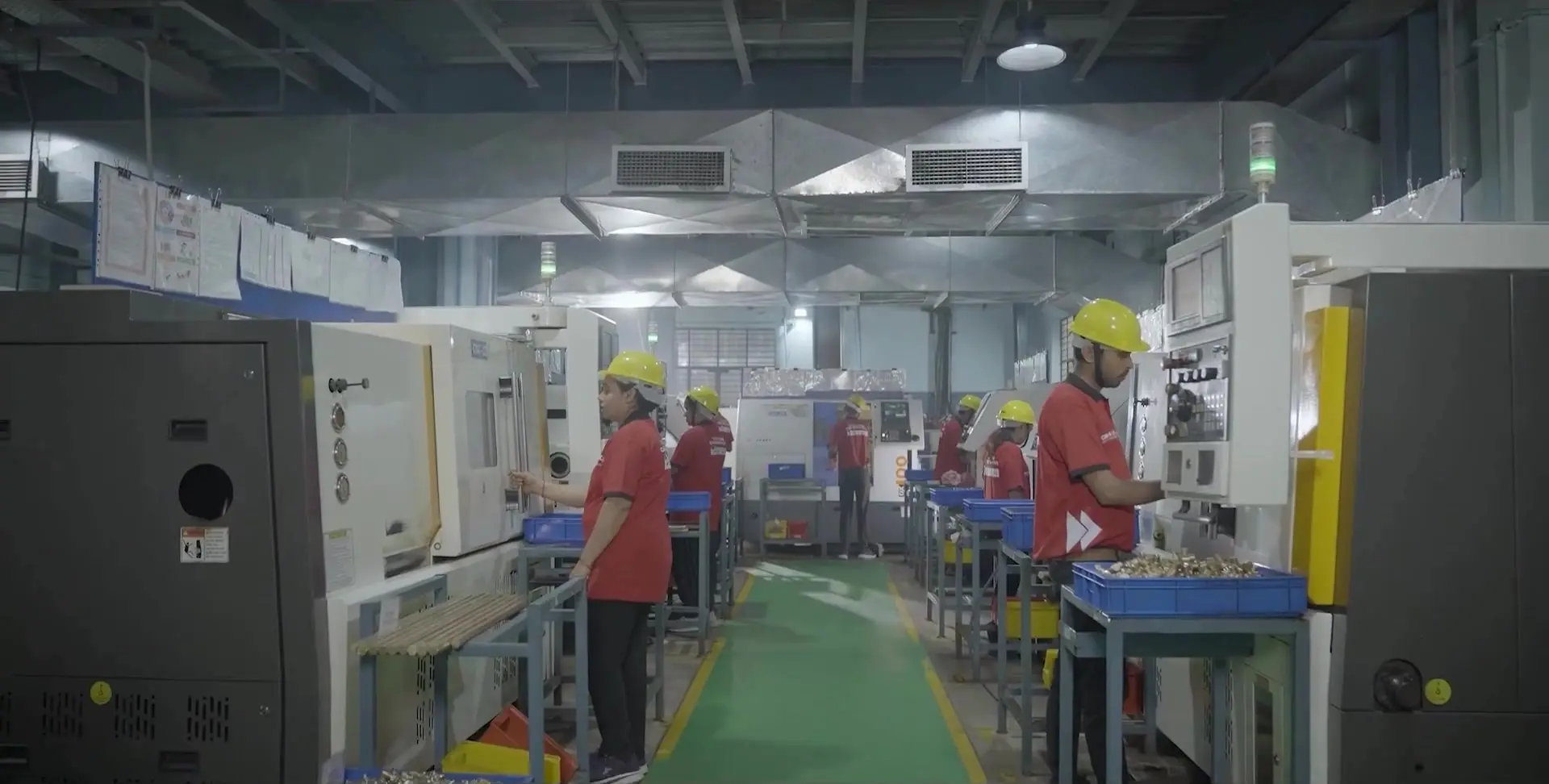 MIJO machining aisle with operators and production equipment